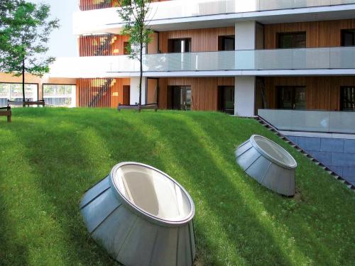 Green roof with pitched areas and skylights and flat areas with small trees